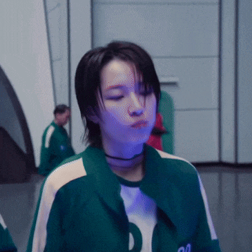 a woman wearing a green jacket with the number 20 on the front