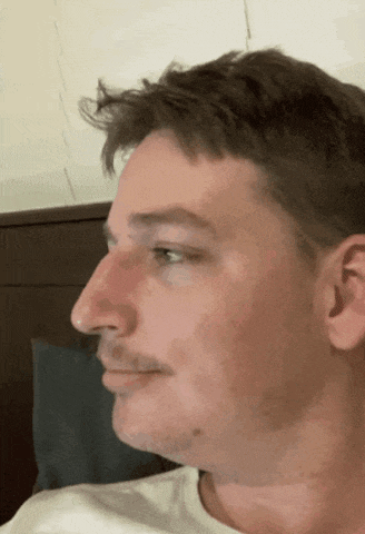 a close up of a man 's face with a beard