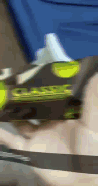 a blurry picture of a person holding a box that says ' sss '