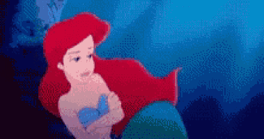 a pixel art of ariel from the little mermaid is swimming in the ocean .