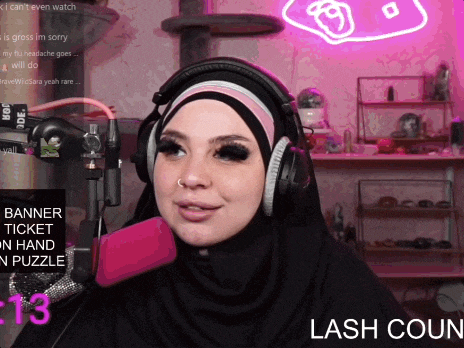 a woman wearing a hijab and headphones talks into a microphone with the words lash coun on the bottom right
