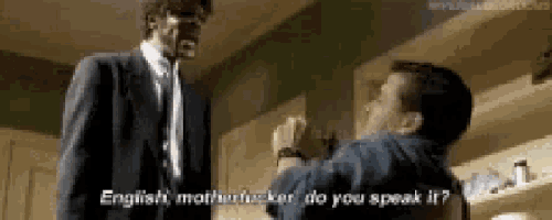 a man in a suit and tie is talking to another man