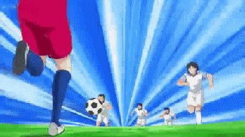 a soccer player in a red shorts is kicking a soccer ball on a field with other players .