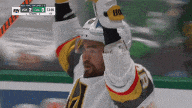a hockey player celebrates a goal during a game against the vegas golden knights