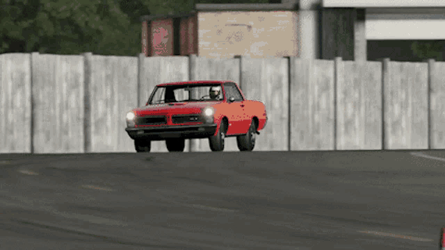 a red gto truck is driving down a street