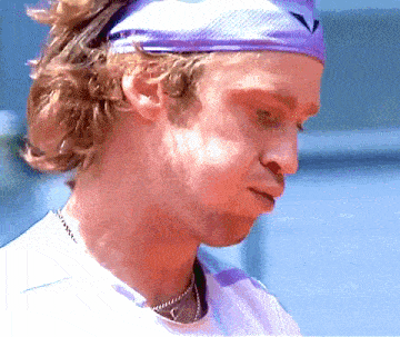 a man wearing a purple headband with a v on it