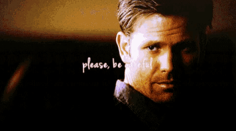 a man in a dark room with the words please be careful above him