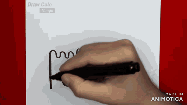 a person is drawing a swirl with a black marker on a piece of paper