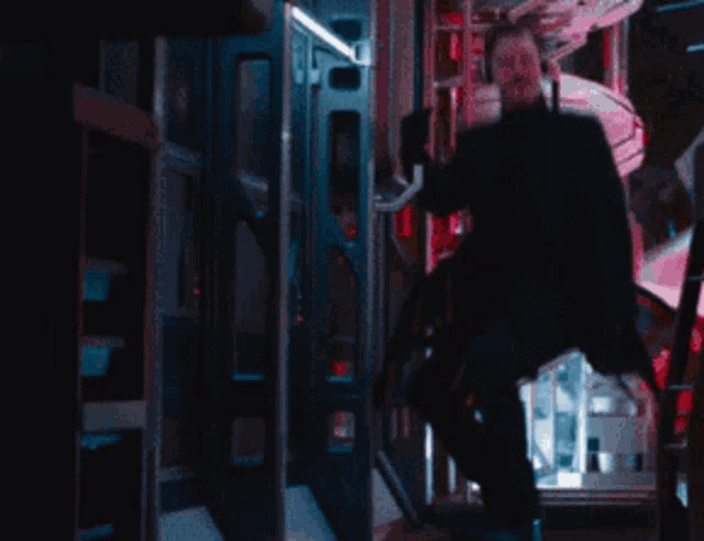a man in a black suit is sitting on stairs