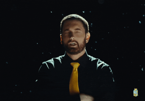 a man wearing a black shirt and a yellow tie