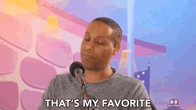 a man is sitting in front of a microphone and says that 's my favorite