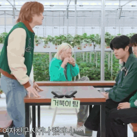 a group of people sitting at a table with a sign on it that says ' g ' on it