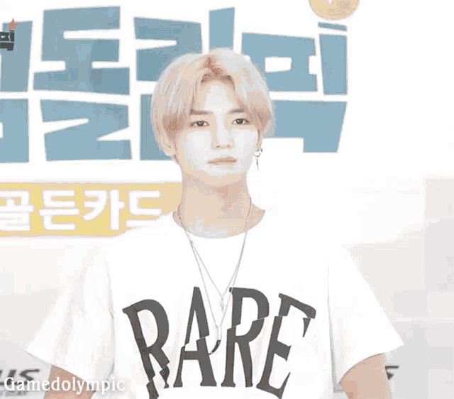 a man wearing a white shirt that says rare on it