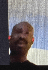 a man with a beard and mustache is standing in front of a window