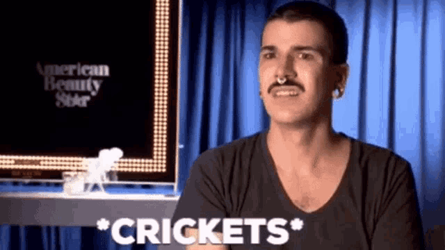 a man with a mustache says crickets in front of an american beauty show