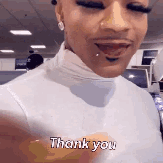 a close up of a person 's face with the words `` thank you '' on it .