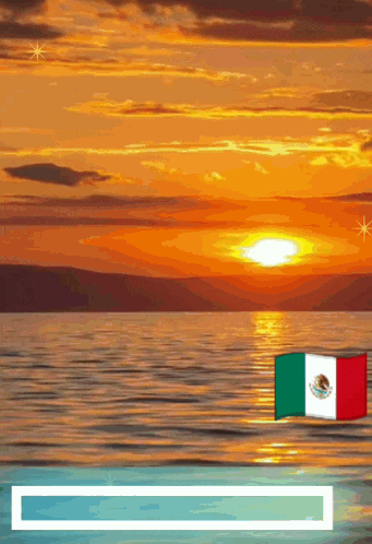 a sunset over a body of water with a flag in the foreground