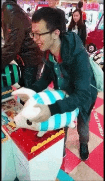 a man holding a stuffed animal in front of a sign that says " only 1 yen "