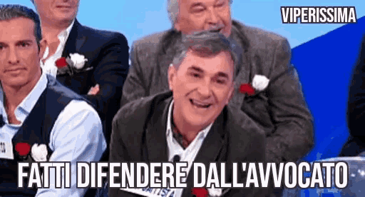 a group of men are sitting in front of a blue background with the words fatti difendere dall ' avvocato