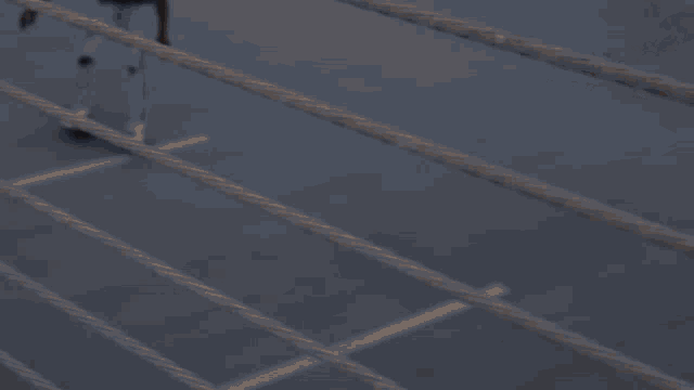 a shadow of a person is cast on the floor