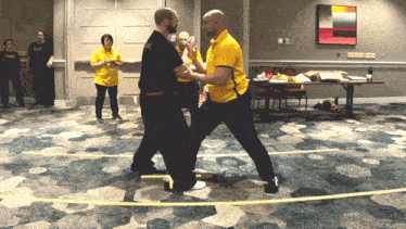 a man in a yellow shirt with the word warrior on it