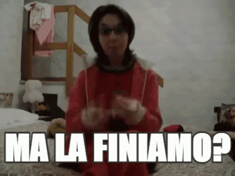a woman is sitting on a bed making a funny face and saying `` ma la finiamo ? '' .