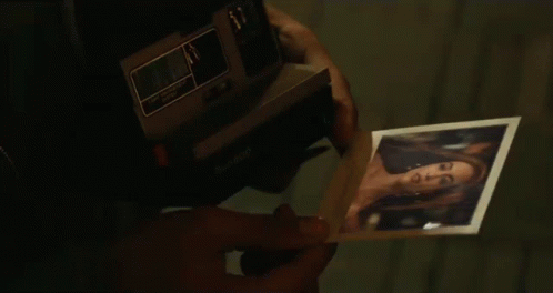 Looking At A Photo Mesmerized GIF - Looking At A Photo Mesmerized Pleased GIFs