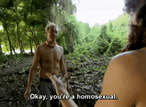 a shirtless man is holding a woman 's hand in the woods and says okay you 're a homosexual