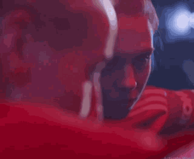 a close up of a person 's face with a red background