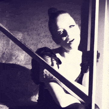a black and white photo of a woman in a bun