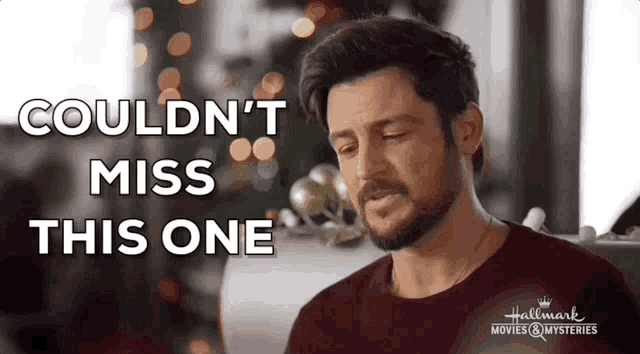 a man with a beard is sitting in front of a christmas tree and says `` couldn 't miss this one ''