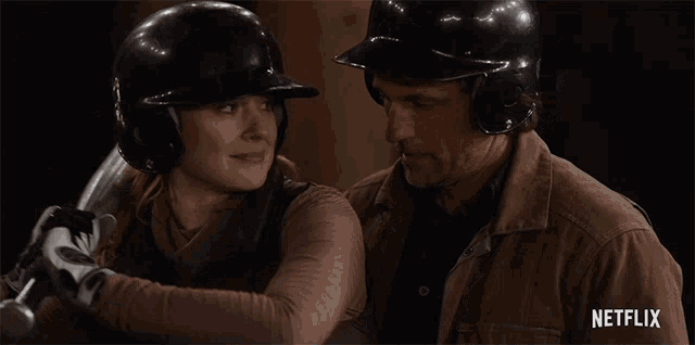a man and a woman looking at each other with netflix written on the bottom right