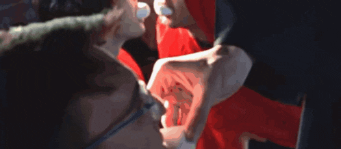 a close up of a person touching another person 's face