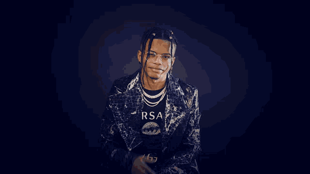 a young man wearing glasses and a jacket that says sa