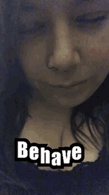 a close up of a woman 's face with the words behave written on it .