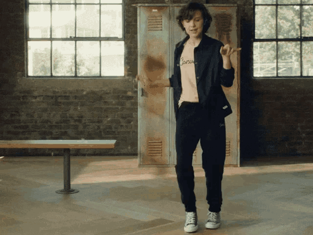a woman wearing a pink shirt that says " brave " is dancing