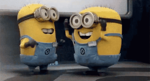 two minions wearing goggles are standing next to each other and smiling .