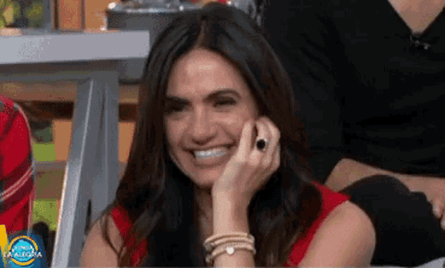 a woman is smiling in front of a sign that says mañana palabra