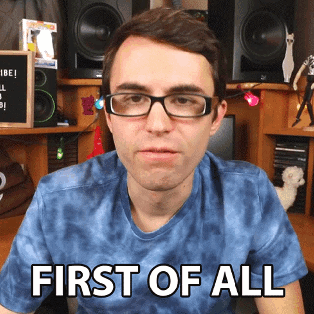 a man wearing glasses and a tie dye shirt says first of all