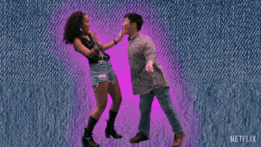 a man and a woman are dancing in front of a netflix ad