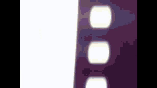 a close up of a purple film strip with white circles