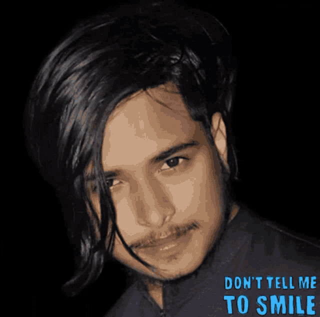 a picture of a man with the words " don 't tell me to smile " underneath it