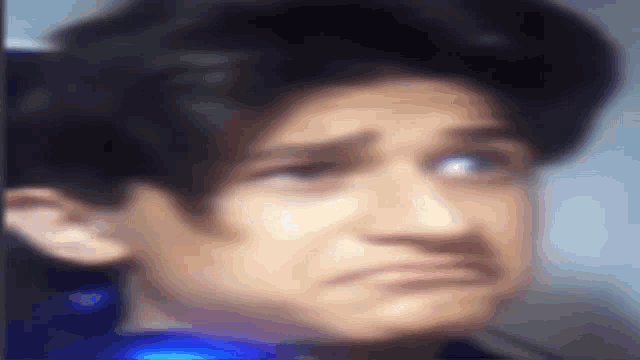 a close up of a person 's face with a sad look on it .