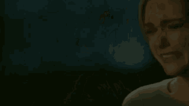 a close up of a woman 's neck and ear while sitting in a dark room .