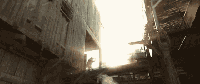 a man is jumping between two buildings with the sun shining through them