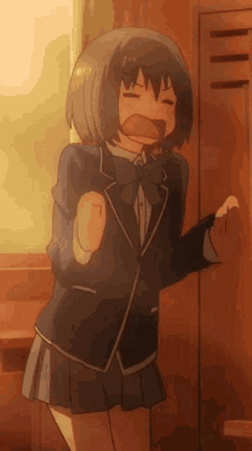 a girl in a school uniform is standing in front of a locker and making a face .