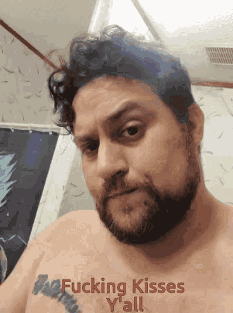 a shirtless man with a tattoo on his chest says fucking kisses yall