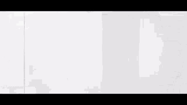 a black and white drawing of a triangle on a white surface .