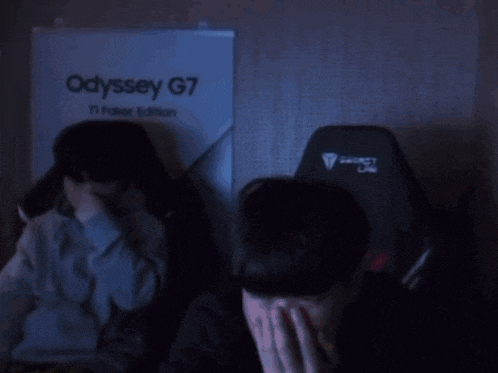 two gaming chairs are sitting in front of a poster that says odyssey g7