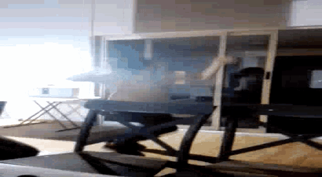 a person playing a keyboard in a room with smoke coming out of the window
